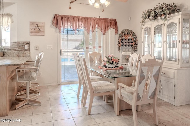 dining area featuring light tile patterned floors and ceiling fan