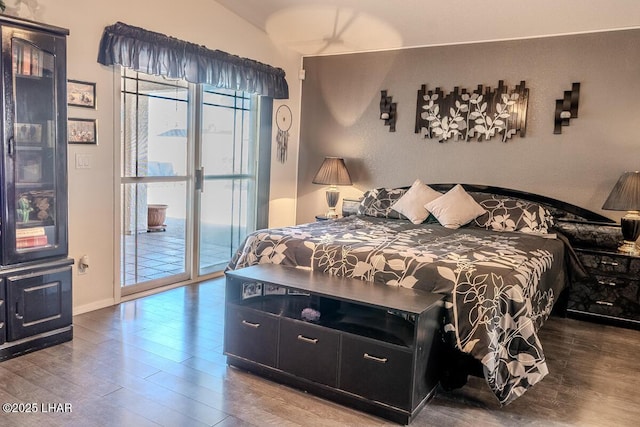 bedroom featuring access to outside, wood finished floors, and baseboards