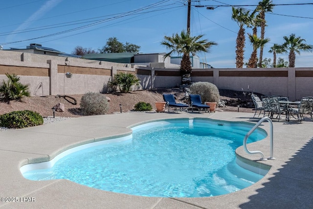 view of swimming pool with a patio area, a fenced backyard, and a fenced in pool