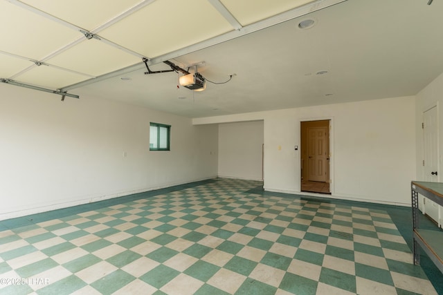 garage with a garage door opener and baseboards