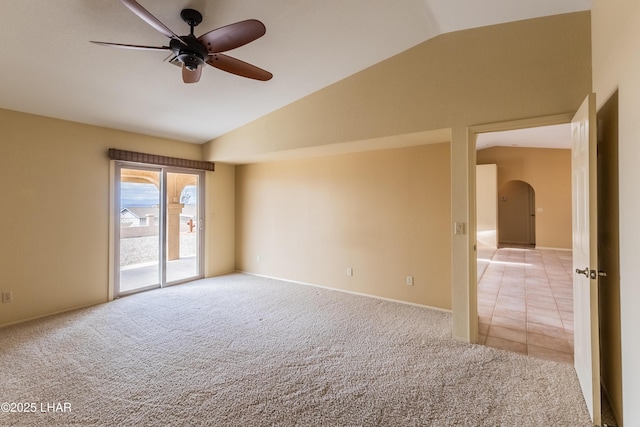 spare room with light carpet, ceiling fan, arched walkways, and lofted ceiling