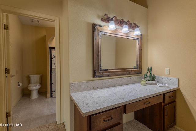 bathroom featuring toilet and vanity