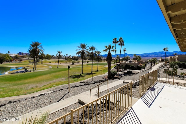 surrounding community with a lawn and a water and mountain view