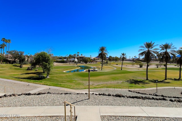 surrounding community featuring a yard and golf course view