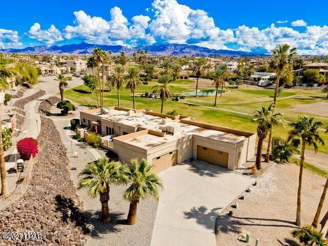 view of property's community featuring driveway and a mountain view