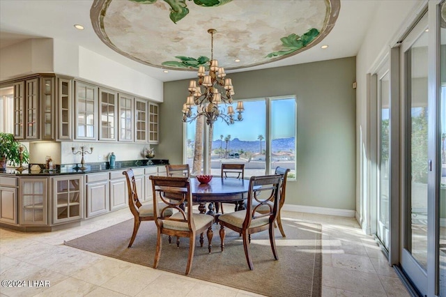 dining area with a mountain view and an inviting chandelier