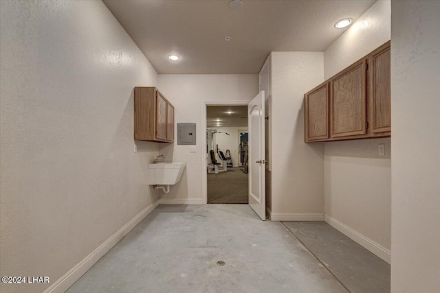 interior space with electric panel and sink