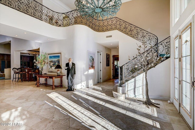 foyer featuring a towering ceiling