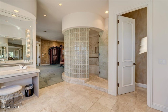 bathroom with vanity and tiled shower