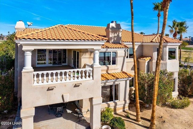 back of house featuring a balcony and a patio area