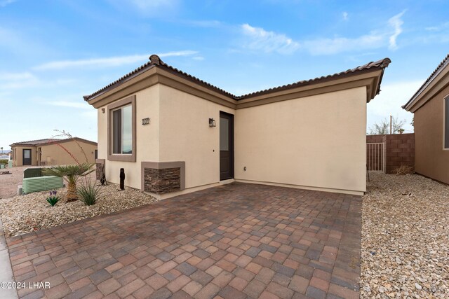 back of property featuring a patio area and central air condition unit