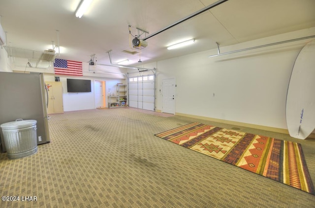 8858 Moovalya Dr, Parker, AZ 85344 - garage with a garage door opener and stainless steel refrigerator