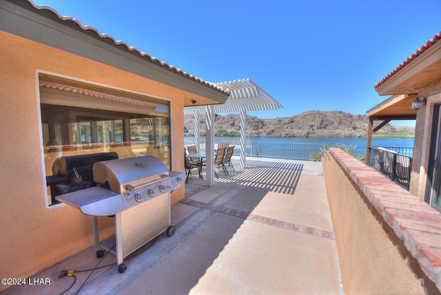 8858 Moovalya Dr, Parker, AZ 85344 - view of patio / terrace featuring a water and mountain view, grilling area, and a pergola