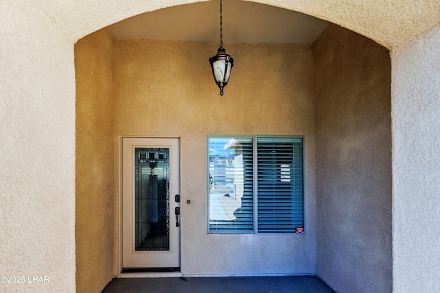 doorway to property with stucco siding