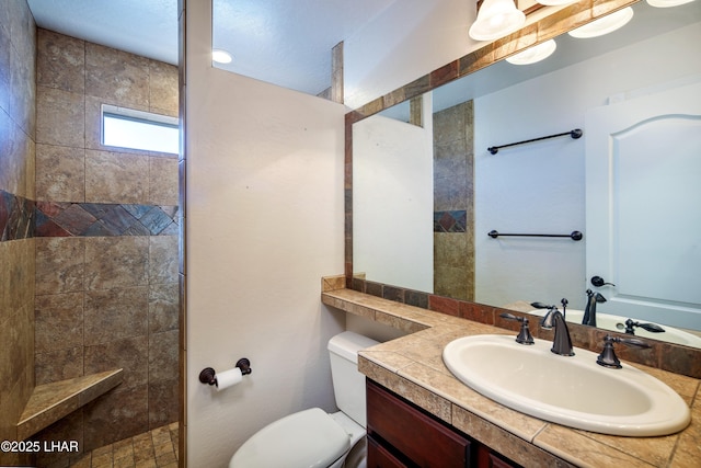 full bathroom with vanity, toilet, and walk in shower