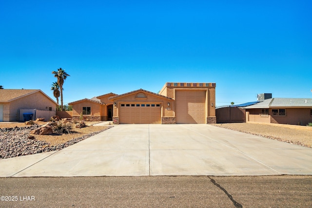 view of front facade with an attached garage, stone siding, concrete driveway, and stucco siding