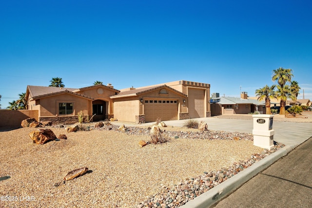 view of front facade with a tile roof, stucco siding, concrete driveway, an attached garage, and stone siding