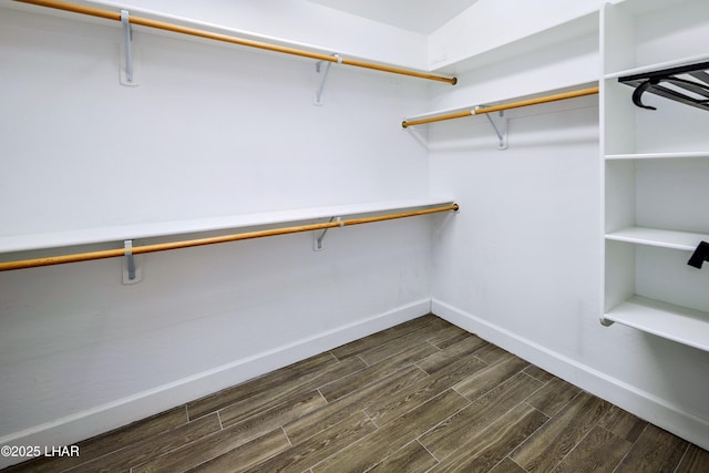 walk in closet with wood tiled floor