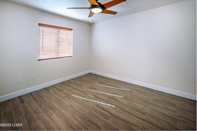 unfurnished room featuring wood finished floors, a ceiling fan, and baseboards