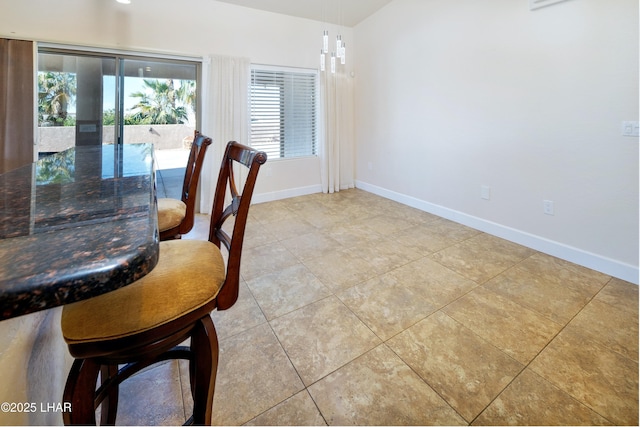 unfurnished dining area featuring tile patterned floors and baseboards