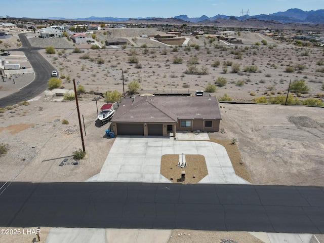 drone / aerial view with a desert view and a mountain view