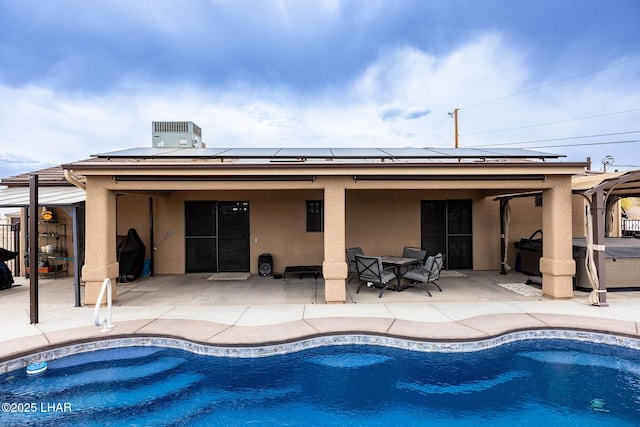 outdoor pool with fence, outdoor dining area, a hot tub, and a patio area