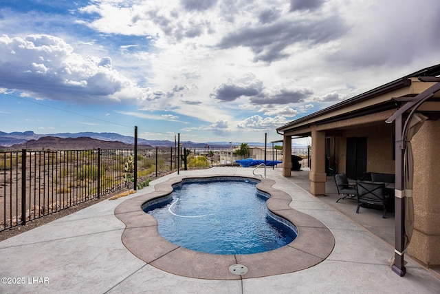 view of swimming pool with a patio, a fenced backyard, a mountain view, and a fenced in pool