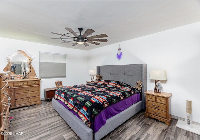 bedroom featuring baseboards, ceiling fan, and wood finish floors