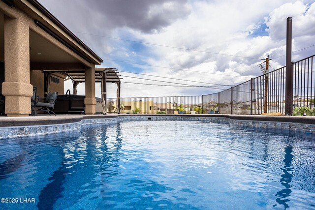 view of pool featuring fence, a fenced in pool, a hot tub, and a patio