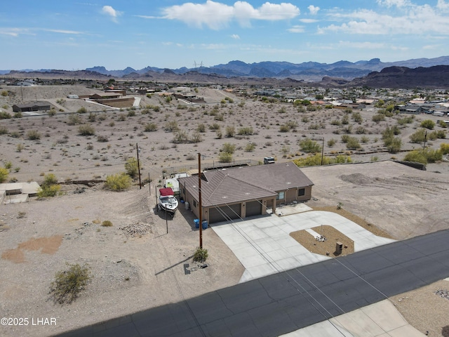 birds eye view of property with a rural view, a mountain view, and a desert view