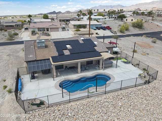 view of swimming pool with a fenced backyard, a patio area, a mountain view, and a residential view