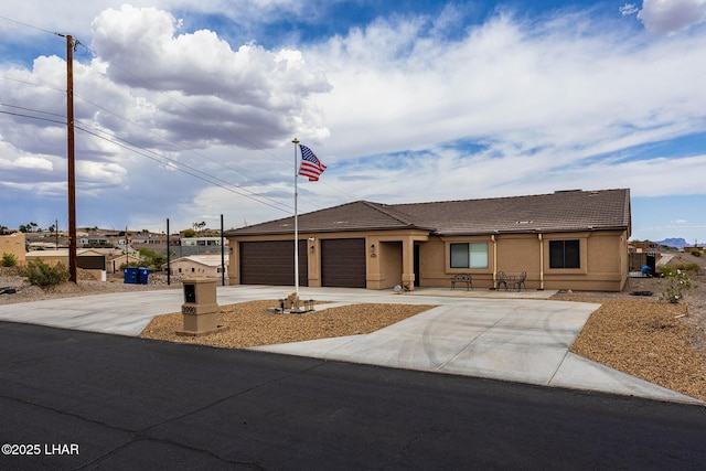 ranch-style house with an attached garage, driveway, and stucco siding