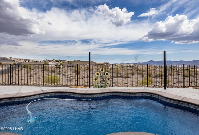 view of swimming pool with a fenced in pool, a mountain view, and fence