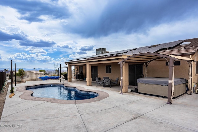 view of swimming pool with a hot tub, a patio, a fenced in pool, and a fenced backyard