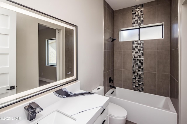 full bathroom with tiled shower / bath combo, toilet, and vanity