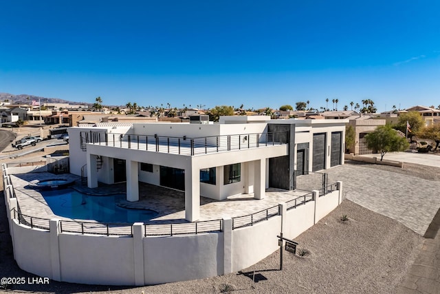 back of house with a balcony and a patio area