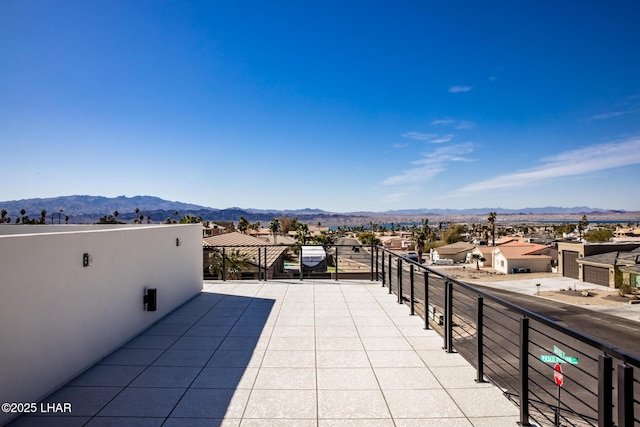 view of patio featuring a mountain view and a balcony