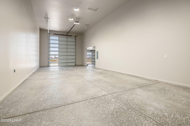 9342 N Broken Saddle Dr, Kingman, AZ 86401 - garage with baseboards and a garage door opener