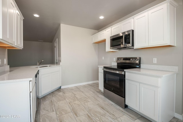 9342 N Broken Saddle Dr, Kingman, AZ 86401 - kitchen featuring appliances with stainless steel finishes, white cabinets, light stone countertops, recessed lighting, and light marble finish floors
