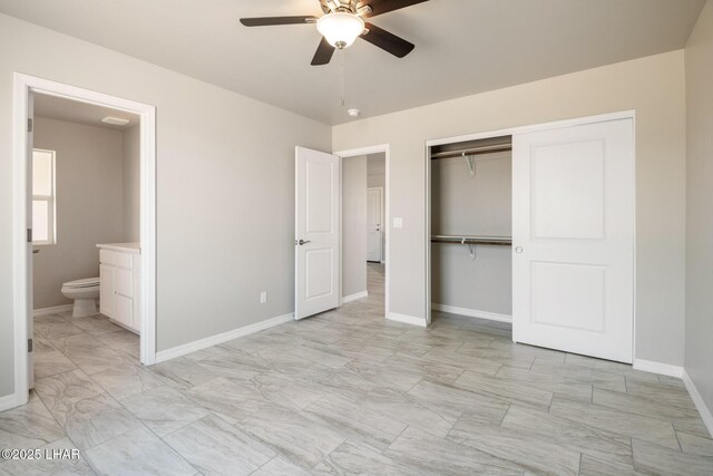 9342 N Broken Saddle Dr, Kingman, AZ 86401 - unfurnished bedroom featuring light marble finish flooring, ensuite bathroom, a closet, and ceiling fan