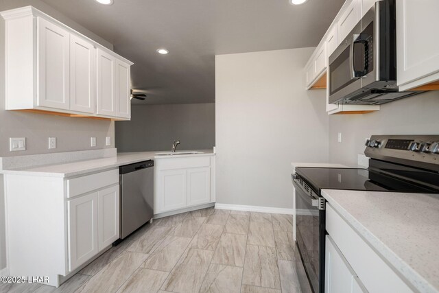 9342 N Broken Saddle Dr, Kingman, AZ 86401 - kitchen featuring stainless steel appliances, light countertops, recessed lighting, white cabinets, and ceiling fan