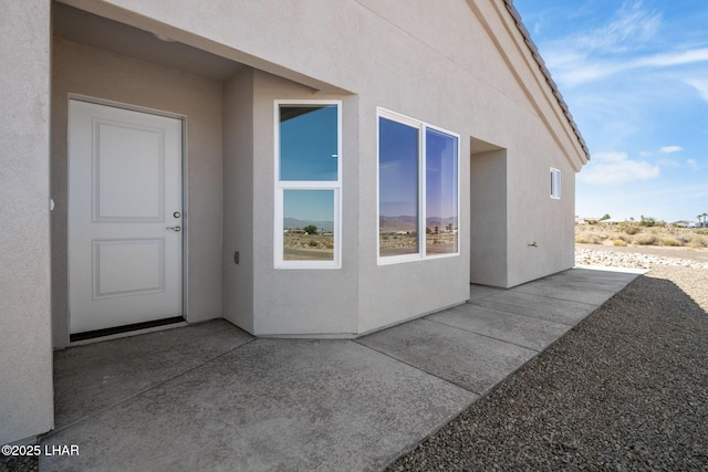 9342 N Broken Saddle Dr, Kingman, AZ 86401 - property entrance featuring stucco siding and a patio