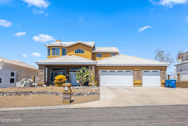 view of front facade with stone siding, concrete driveway, an attached garage, and a tile roof