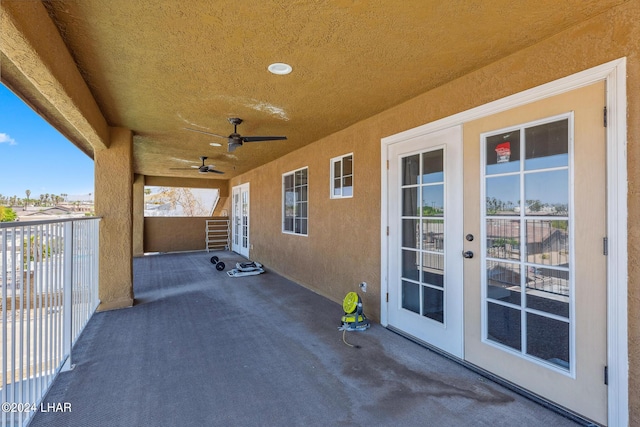 view of patio featuring a balcony, ceiling fan, and french doors