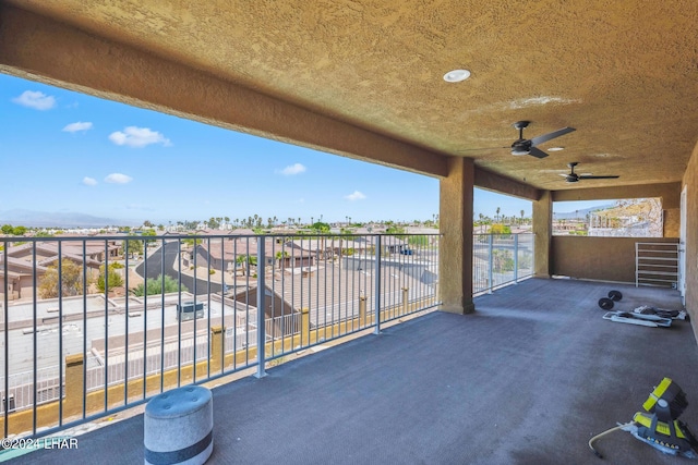 view of patio featuring ceiling fan and a balcony