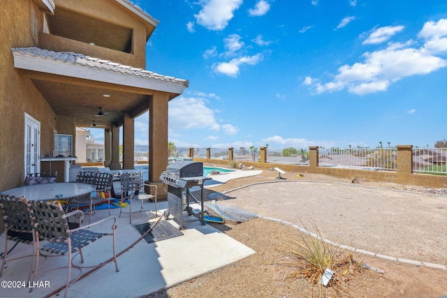 view of patio / terrace with a ceiling fan, a fenced in pool, a grill, and fence