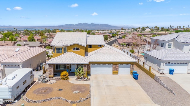 birds eye view of property with a mountain view and a residential view