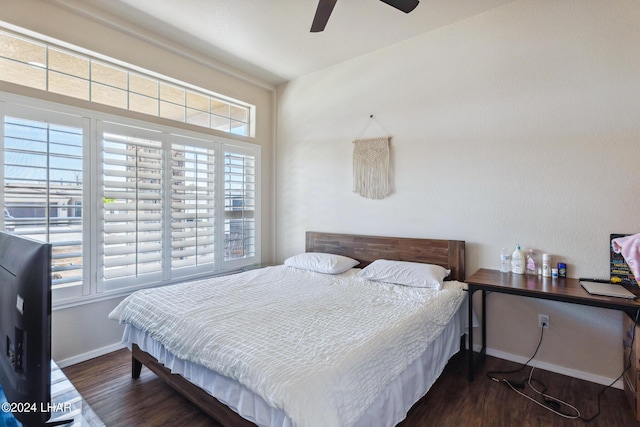 bedroom with multiple windows, dark wood-style flooring, a ceiling fan, and baseboards