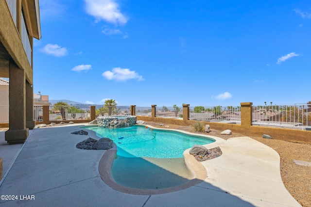 view of swimming pool with a mountain view, a patio, a fenced backyard, and a pool with connected hot tub