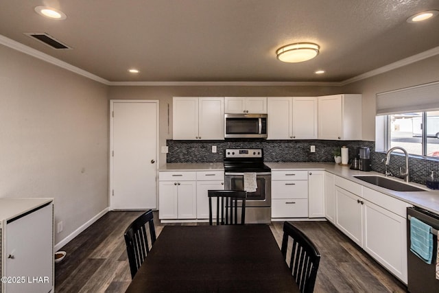 kitchen featuring white cabinetry, stainless steel appliances, and light countertops